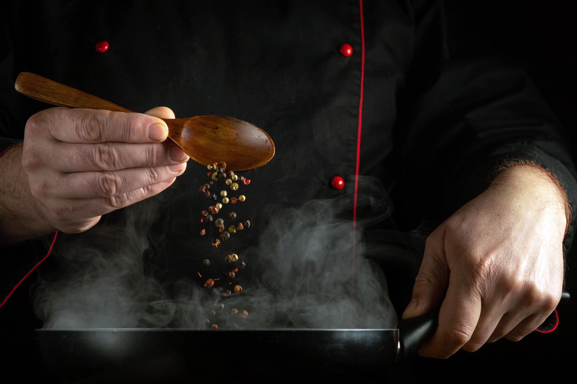 Chef hands seasoning dish